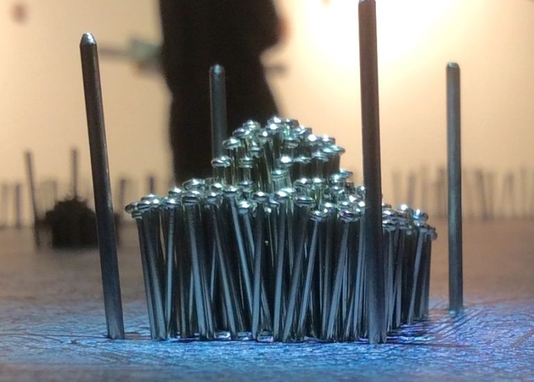 Threshold physical mapping model with contoured terrain, colored regions, and radiating thread connections.